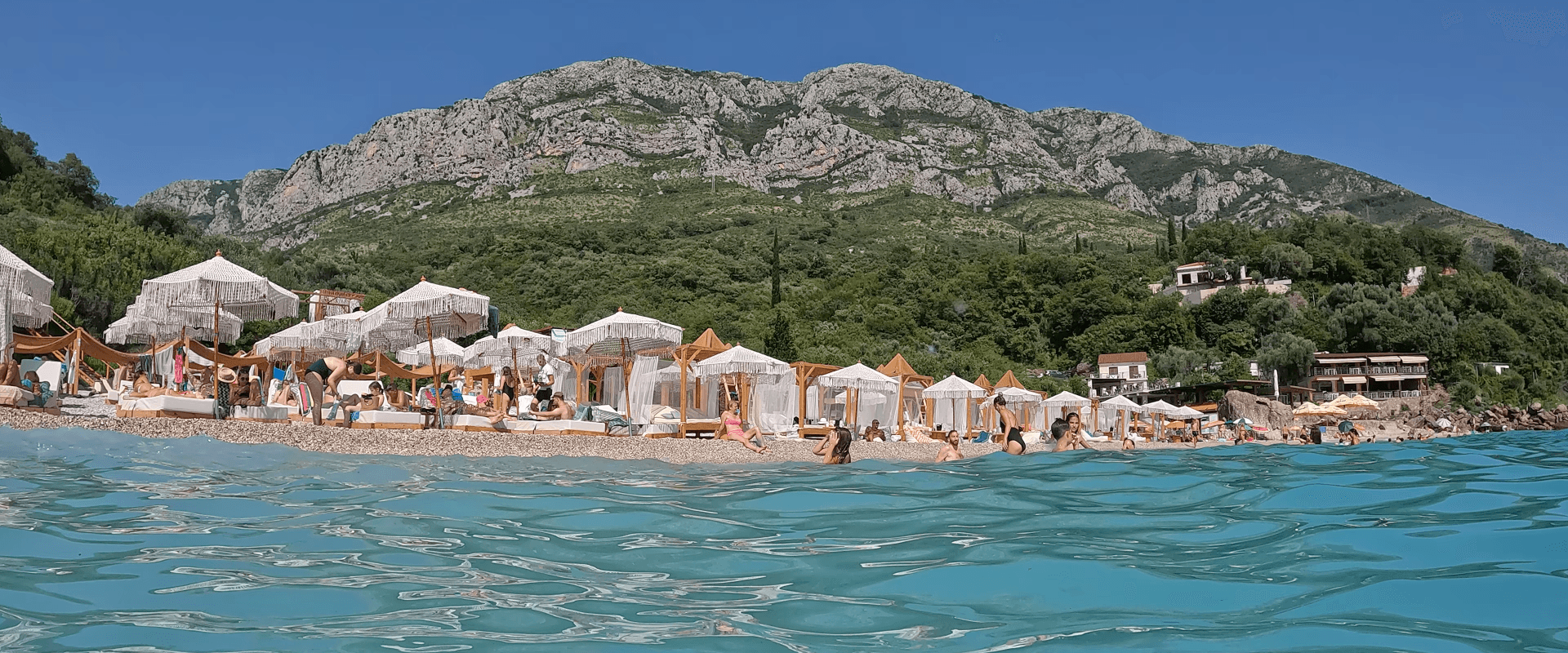 Adventures banner image with the seaview with trees, mountains and sandy beach